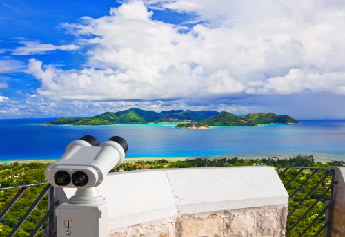 Binoculars and island Praslin at Seychelles - nature background