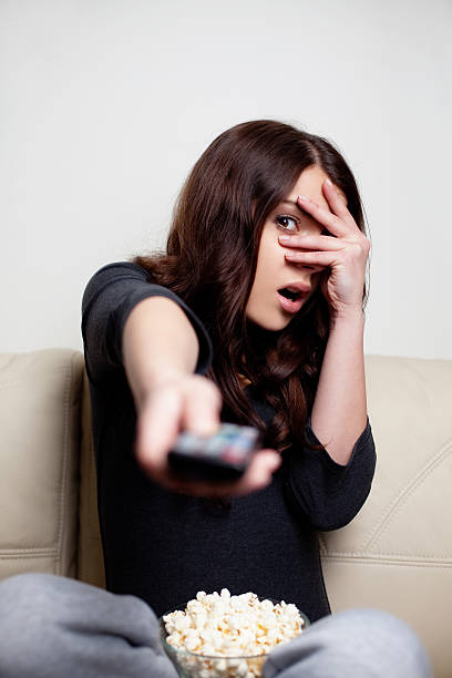 istock Scared young woman watching television 162722132