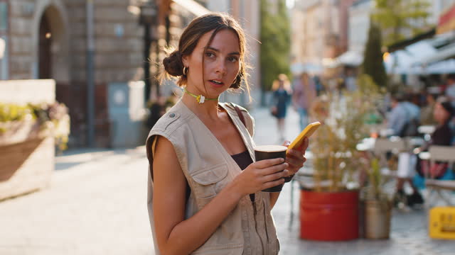 Tourist traveler woman girl using looking smartphone search a way on map in mobile navigator app