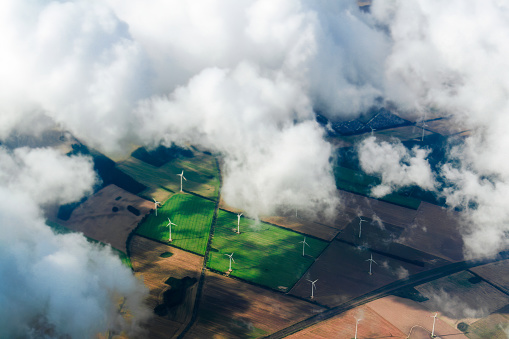 aerial view of wind turbine farm. Wind power plants in green landscape. sky with clouds. agricultural landscape