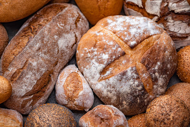 istock Freshly baked natural bread is on the kitchen table. 1627309047