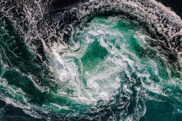 Photo of Blue waves of water of the river and the sea meet each other during high tide and low tide.