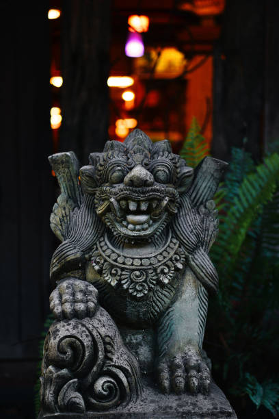 Old stone lion decorated in Bali garden stock photo
