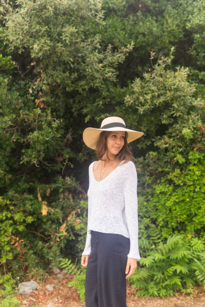 istock Young woman in sunhat explores forest 1627322390