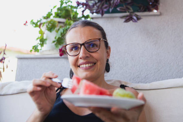istock The young woman enjoying her fruit break. 1627326481