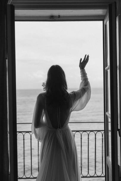 istock Bride stands on balcony over sea 1627330922