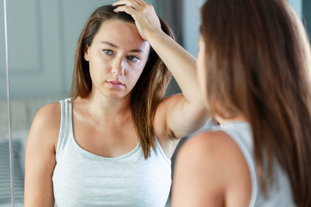 istock Upset woman standing front on mirror and thinking of her problems and depression 1627330955