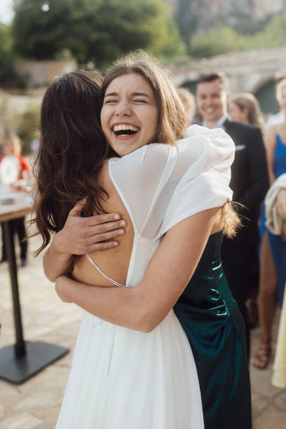 istock Bride and sister embrace at wedding 1627330997