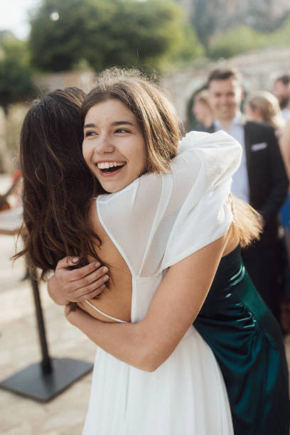 istock Bride and sister embrace at wedding 1627331002