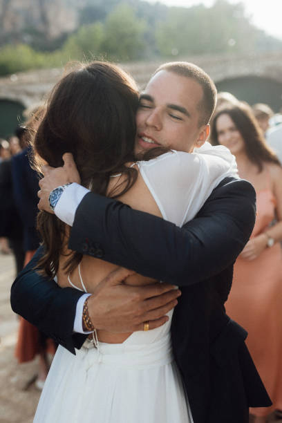 istock Bride and brother embrace at wedding 1627331010