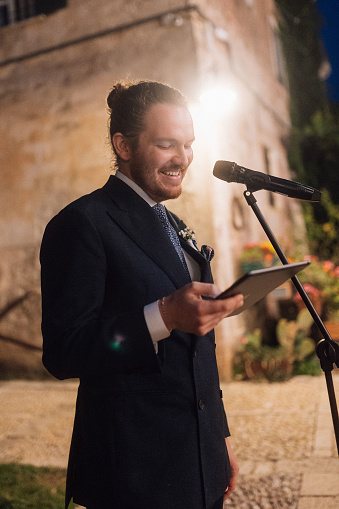 He is giving a speech at his wedding ceremony