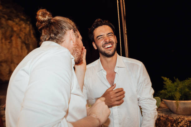 Groom and best man laugh together