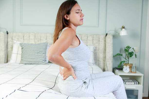 istock Young woman suffering with back pain 1627332706