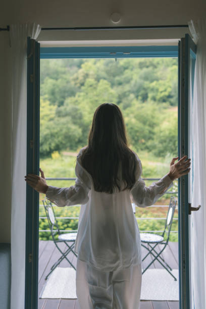 istock Young woman on veranda in countryside 1627333844