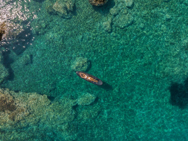 istock Bird's-eye view woman lying on SUP board 1627337707