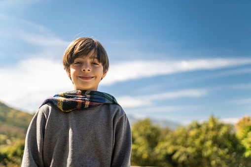 Portrait of boy looking at camera outdoors in winter