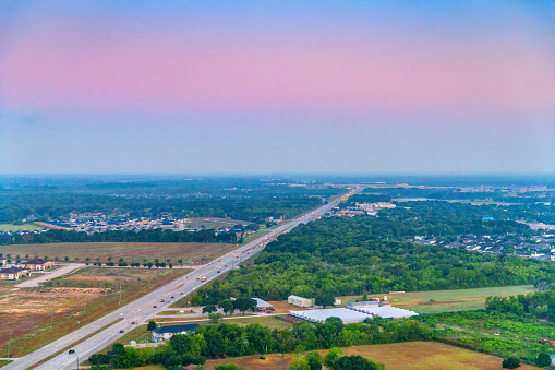 The rural landscape of Arcola, Texas located about 30 miles south of Houston from a helicopter at about 400 feet in altitude at daybreak just before the sun rose over the horizon.