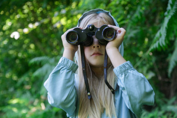 istock Cute little girl exploring nature looking through binoculars. Child playing outdoors. Kids travel, adventure and bird watching concept. 1627357855