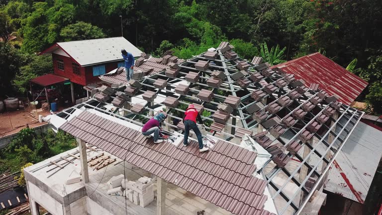 Aerial drone shot of roofers work on the roof.