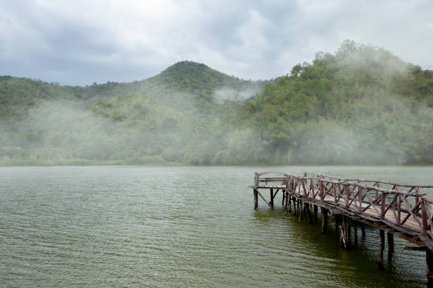 The wooden bridge that stands down to a reservoir named Khao Wong is a tourist attraction of Suphanburi province in Thailand