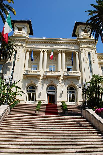 San Remo casino San Remo casino white facade with palms and flowers, Liguria, Italy san remo italy photos stock pictures, royalty-free photos & images