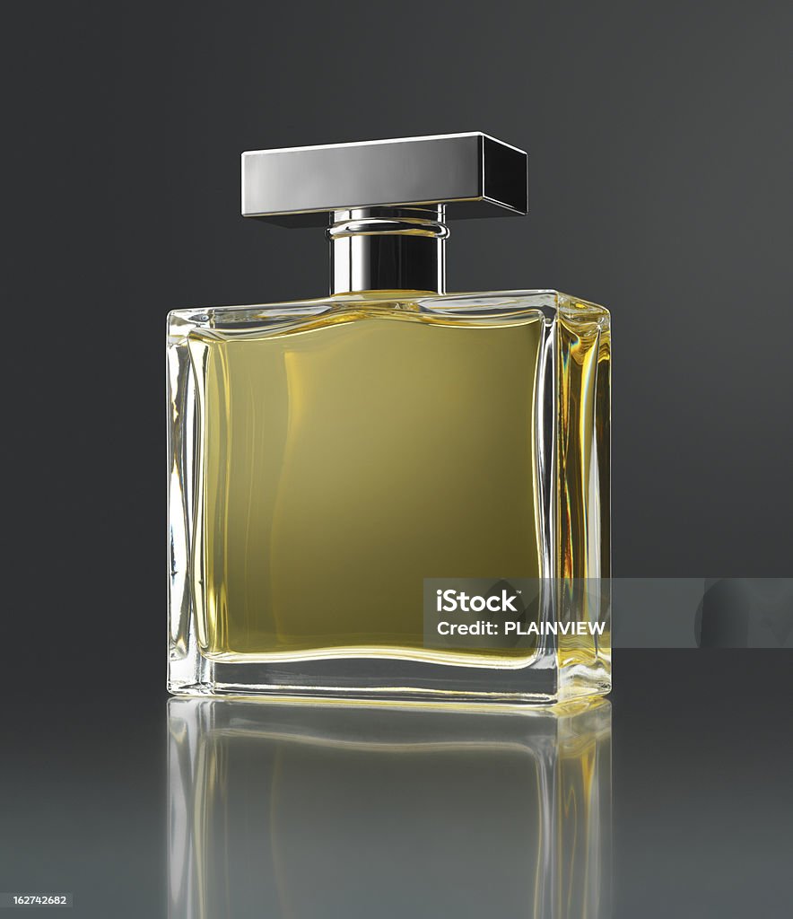 Perfume bottle Perfume bottle with reflection on gray background (original flask inspired by several forms) Perfume Stock Photo