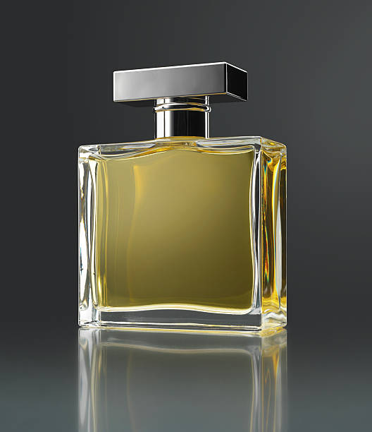 Perfume bottle Perfume bottle with reflection on gray background (original flask inspired by several forms) perfume bottle stock pictures, royalty-free photos & images