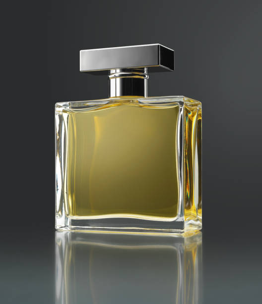 Perfume bottle Perfume bottle with reflection on gray background (original flask inspired by several forms) attraction studio photography stock pictures, royalty-free photos & images