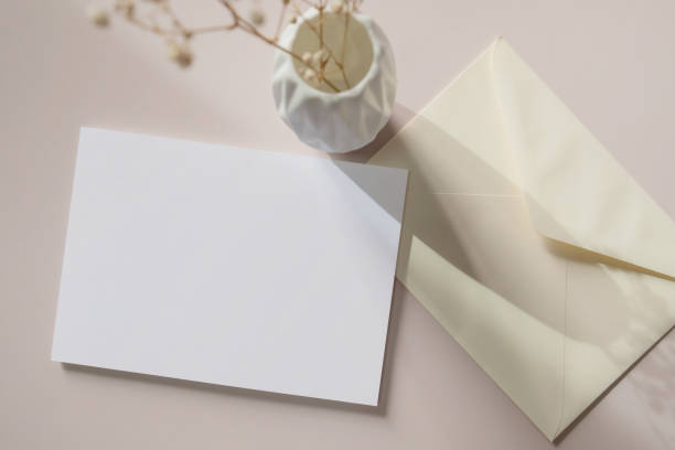 istock White blank greeting or invitation card and envelope with ceramic jar decoration on white background. 1627440050