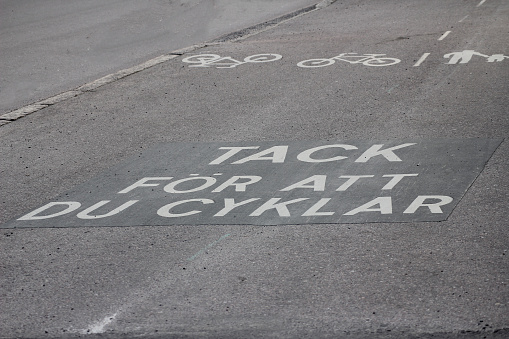 Text on the road on Swedish saying : Thank u for riding your bike