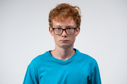 Portrait of sad boy on white background