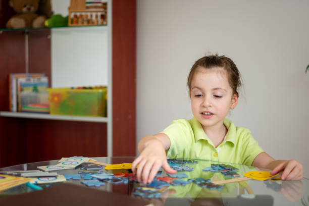 istock Cute little girl solving puzzles 1627462122