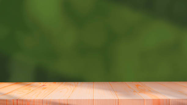 istock Empty wooden table with sunlight and shadow on blurred green interior wall background, suitable for product mockup display presentation 1627462854