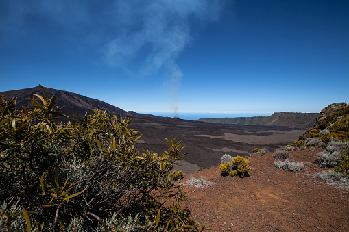 Stunning view of a religious stone shrine on the summit of Mauna Kea volcano (4205 m) on the Big Island of Hawaii. Astronomical observatories in the background. Famous tourist destination.