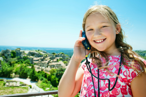 Little girl listening to audio tour in Provence, France