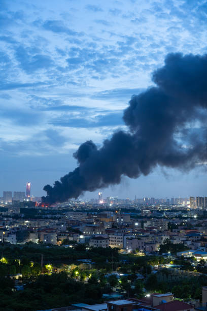 istock a factory catched a fire with lots dark smoke in sunset time vertical composition 1627484023