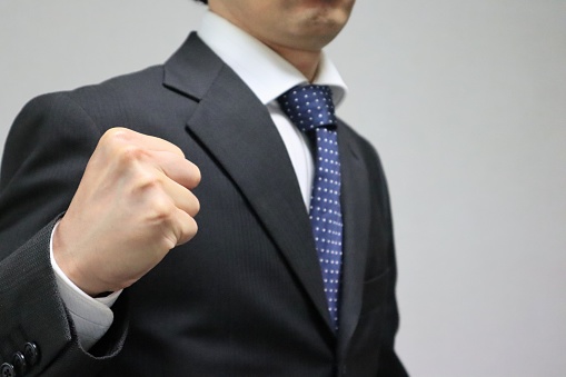 Photo of a businessman holding a fist