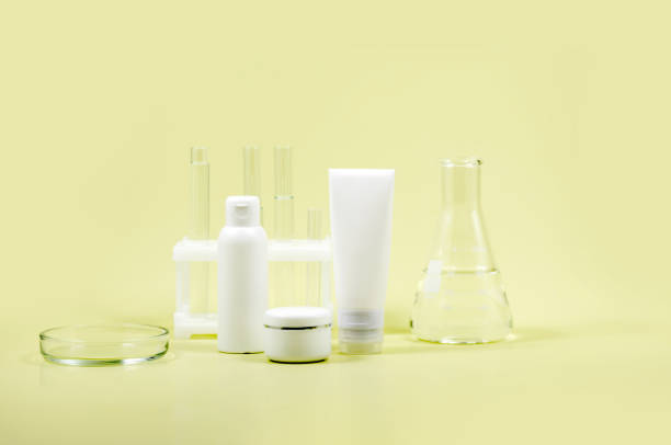 istock Cosmetic containers, Petri dish and laboratory flasks on a yellow background 1627513761