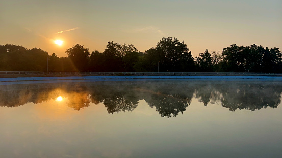 This photograph is taken at Lac de Robertville in Belgium. It was a true magical moment, with the mysterious mist above the water surface and the amazing colors in the sky.