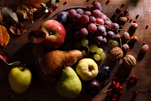 Pear, grape, quince, and other autumn fruits on a rustic  table