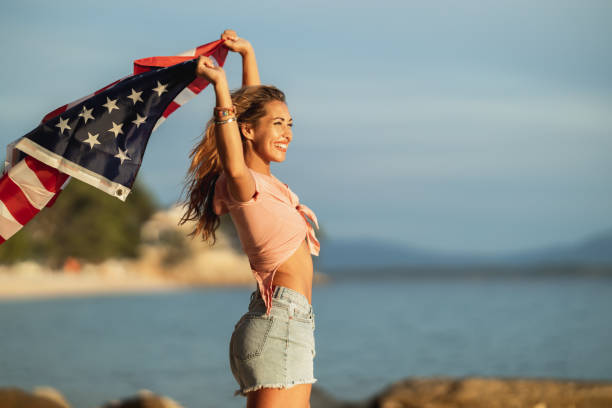 istock Young Woman With US National Flag 1627555855