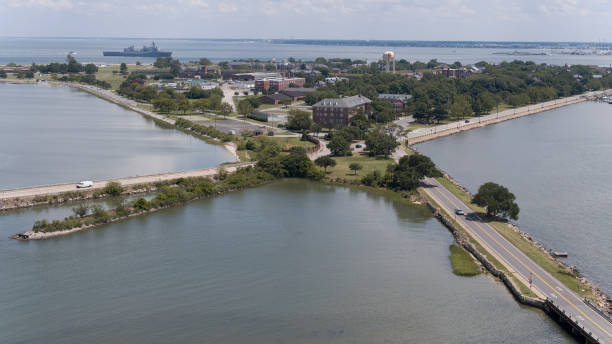 istock Roads intersections in Fort Monroe on Virginia Peninsula. Mercury Blvd and E Mellen Street cross-section in Fort Monroe, Hampton, VA. Old military ship on the horizon. Aerial view 1627556358