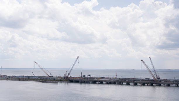 istock Bridge and tunnels construction, gantry cranes working in water surroundings. Hampton Roads Beltway, North Island, VA. Aerial view 1627556908