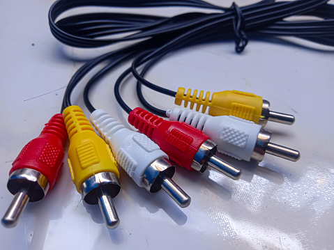 RCA cable, audio and video on white background. Yellow,red and white cable. selective focus