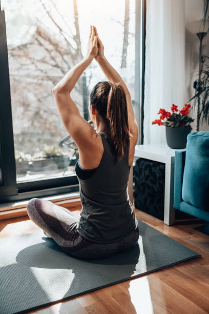 istock Woman Practicing A Yoga Routine At Home 1627572119
