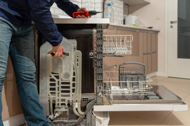 istock Repairman fixing the dishwasher 1627577815
