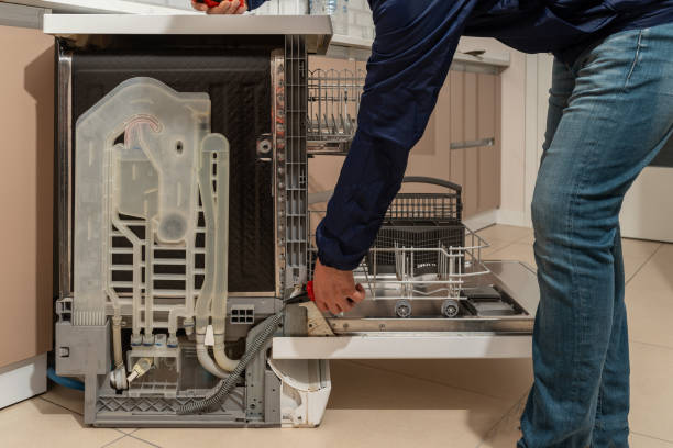 istock Repairman fixing the dishwasher 1627582304