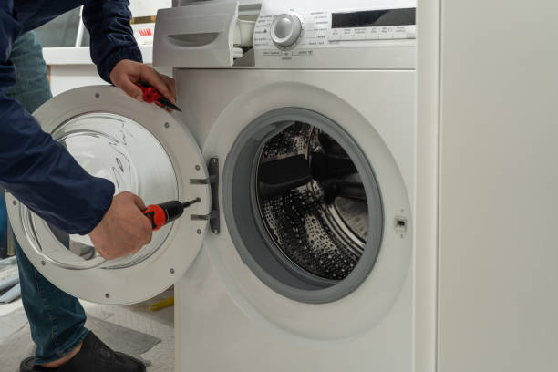 istock Repairman fixing the washing machine 1627593959