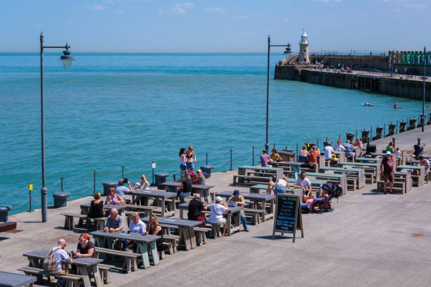 Folkestone, UK - 9 July 2023: Outdoor dining terrace, Folkestone Harbour Arm, Kent