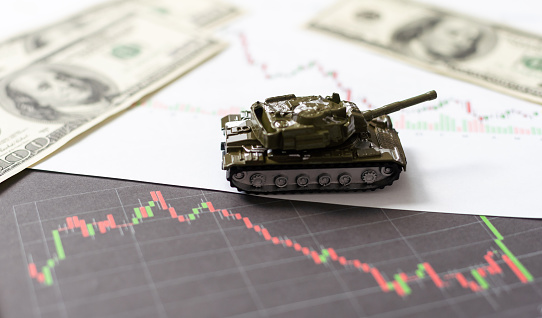 Businessman on a tanks with confidence and diagrams rising stock. High quality photo